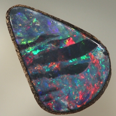 SOLID BOULDER OPAL Bright red and green surround black opal bands 